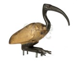 Carved wooden squatting ibis,...